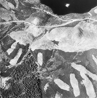 Oblique aerial view centred on the remains of possible shieling-huts, trackway and possible hut-circle with possible artificial island adjacent, taken from the SSW.