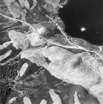 Oblique aerial view centred on the remains of possible shieling-huts, trackway and possible hut-circle with possible artificial island adjacent, taken from the SSE.