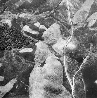 Oblique aerial view centred on the remains of possible shieling-huts, trackway and possible hut-circle, taken from the ESE.