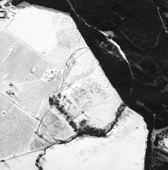 Oblique aerial view centred on the remains of the homestead and field-system, with the remains of the hut-circle, homestead, and building adjacent, taken from the ENE.