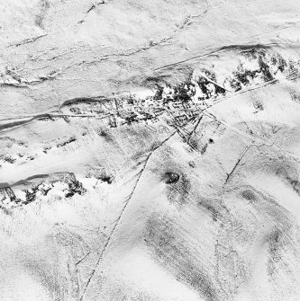 Oblique aerial view centred on the remains of the township, limekiln and homestead, taken from the SW.