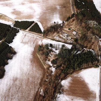 Oblique aerial view centred on the remains of the possible motte and tower-house, taken from the SE.