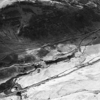 Oblique aerial view centred on the remains of a sheepfold, field banks and rig, taken from the E.