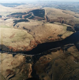 General oblique aerial view looking across the reservoir towards the remains of the fort, taken from the WSW.