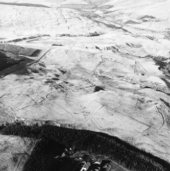 Oblique aerial view centred on the remains of the field-system, rig and trackway, taken from the SE.