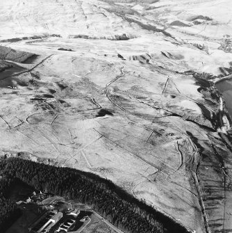 Oblique aerial view centred on the remains of the field-system, rig and trackway, taken from the SE.