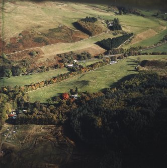 Oblique aerial view centred on the country house and the remains of the plantation bank with the steading adjacent, taken from the W.