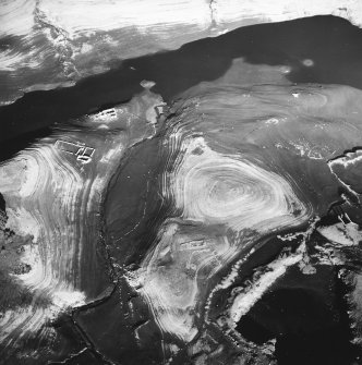 Oblique aerial view centred on the remains of the farmstead with another farmstead, sheepfold, enclosures and quarry adjacent, taken from the S.