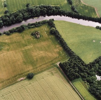 Oblique aerial view of Innerpeffray centred on the remains of the tower house and the cropmarks of a possible garden, and a pit-alignment, taken from the NNE.