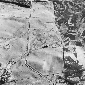 Glen Fender, oblique aerial view, taken from the NNE, centred on the remains of a township. A farmstead is visible in the centre left of the photograph, and small cairns and buildings in the top centre.