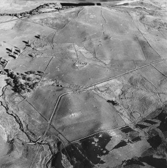 Glen Fender, oblique aerial view, taken from the NW, centred on the remains of a farmstead and buildings. The remains of two townships are visible in the centre left and centre right of the photograph.