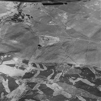 Glen Fender, oblique aerial view, taken from the WNW, centred on the remains of a township. Footings of two buildings are visible in the bottom half of the photograph, and of a farmstead and buildings in the top centre.