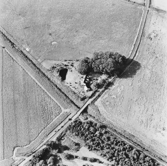 Inchaffray Abbey, oblique aerial view, taken from the SE, centred on the remains of the abbey. A road bridge is visible in the bottom centre of the photograph.