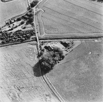 Inchaffray Abbey, oblique aerial view, taken from the NE, centred on the remains of the abbey. A road bridge is visible in the centre of the photograph.