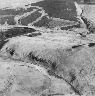 Oblique aerial view centred on the remains of field banks, a field-system, rig and possible lazy beds, taken from the W.