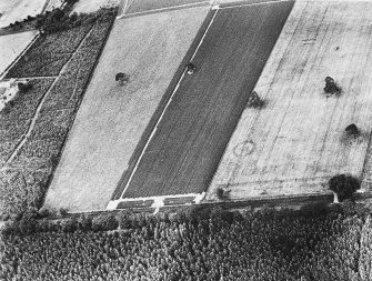 Oblique aerial view centred on the cropmarks of the watch tower, taken from the SSE.