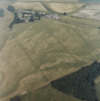 Oblique aerial view centred on the cropmarks of enclosures, henges, ring-ditches, a pit-enclosure and barrows, taken from the SSE.