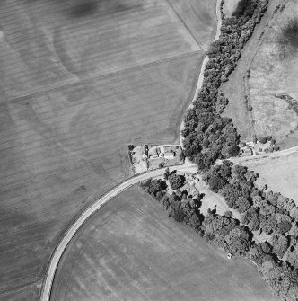 Oblique aerial view centred on the house, gate-lodge and cottage with the cropmarks of rig adjacent, taken from the SSE.