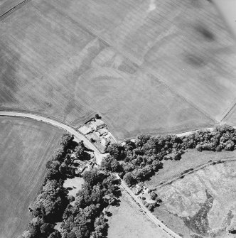 Oblique aerial view centred on the house, gate-lodge and cottage with the cropmarks of rig adjacent, taken from the E.