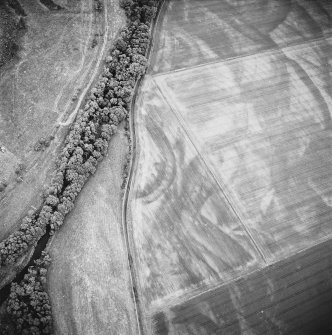 Oblique aerial view centred on the geological cropmarks with rig adjacent, taken from the NNW.