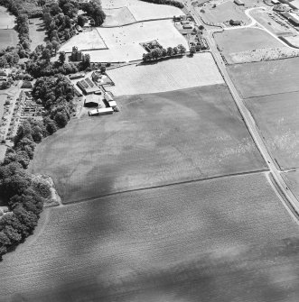 Oblique aerial view centred on the cropmarks of an enclosure, pit-circle, Roman Road, linear cropmarks, pits and pit-alignment with castle adjacent, taken from the WNW.