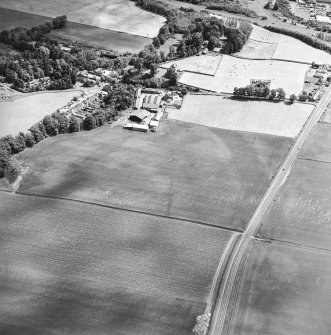 Oblique aerial view centred on the cropmarks of an enclosure, pit-circle, Roman Road, linear cropmarks, pits and pit-alignment with castle adjacent, taken from the WSW.
