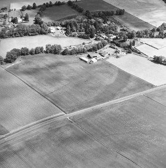 Oblique aerial view centred on the cropmarks of an enclosure, pit-circle, Roman Road, linear cropmarks, pits and pit-alignment with linear cropmarks and castle adjacent, taken from the SSW.