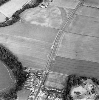 Oblique aerial view of Huntingtower and Huntingtower Mains centred on the cropmarks of a Roman road, enclosure, pit-circle, pits and various linear cropmarks and miscellaneous cropmarks, taken from the WSW.