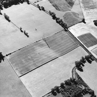 Oblique aerial view centred on the cropmarks of the enclosure, pit-alignment and possible Roman watch tower, taken from the E.