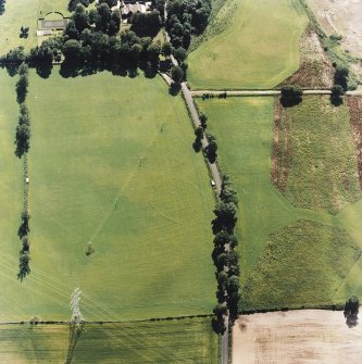 Oblique aerial view centred on the cropmarks of the enclosures and pit-alignment, taken from the ENE.