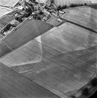 Oblique aerial view of Victoria Cottage centred on linear cropmarks with village adjacent, taken from the SW.