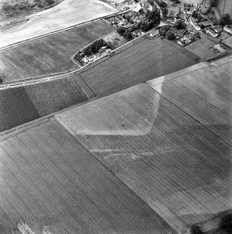 Oblique aerial view of Victoria Cottage centred on linear cropmarks with village adjacent, taken from the SSW.