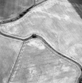 Oblique aerial view of Northleys centred on the cropmarks of a souterrains, possible souterrains, cultivation remains, pits, and other miscellaneous cropmarks, taken from the E.