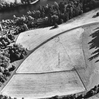 Dunkeld, oblique aerial view, taken from the NNE, centred on the cropmarks of Dunkeld House. Dunkeld Cathedral is visible in the top left-hand corner of the photograph.