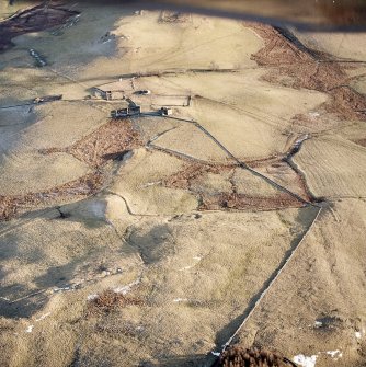 Oblique aerial view centred on the remains of the farmstead, buildings and tower-house, with the remains of the farmstead adjacent, taken from the NW.