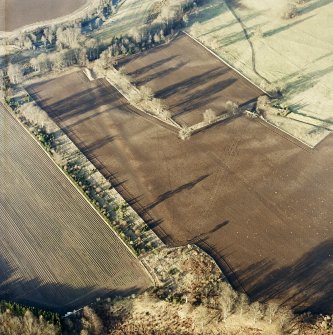 Oblique aerial view centred on the soilmark of the linear earthwork, taken from the S.