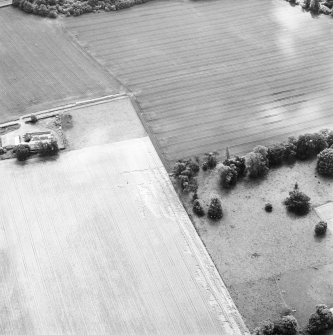 Oblique aerial view of Carpow centred on the cropmarks of a Roman fort and temporary camps, taken from the N.