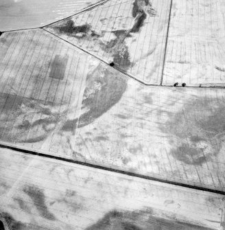 Oblique aerial view centred on the cropmarks of the pit-defined cursus, pits and rig, with pits, rig, ring-ditch and possible quarry adjacent, taken from the SSE.