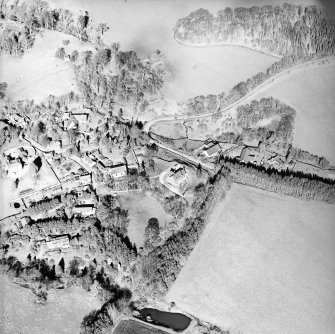 Oblique aerial view centred on the remains of the motte and the church and burial-ground, taken from the S.