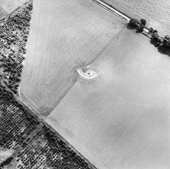 Oblique aerial view centred on the remains of the excavated souterrain, taken from the WNW.