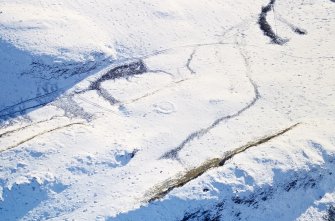 Oblique aerial view of Castle Hill centred on the remains of a ring-ditch house with a fort and mound adjacent, taken from the N.