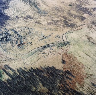 Oblique aerial view of Glen Muick centred on the remains of a township, rig and head-dyke, taken from the W.