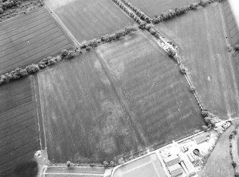 Oblique aerial view centred on the cropmarks of pits, a roundhouse, possible enclosure and rig, taken from the ESE.