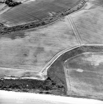 Oblique aerial view centred on the cropmarks of the unenclosed settlements, linear cropmarks and possible field boundaries, taken from the ENE.