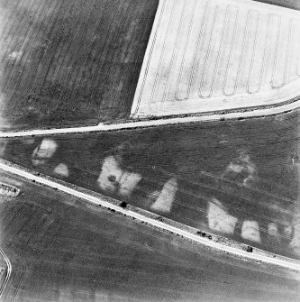 Bandoch, oblique aerial view, taken from the SE, centred on the cropmarks of a round house.