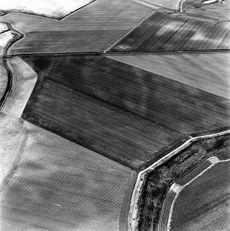 Newbarns, oblique aerial view, taken from the ENE, centred on the cropmarks of an unenclosed settlement and linear cropmarks.