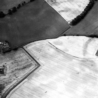 Newbarns Smithy, oblique aerial view, taken from the NNE, centred on cropmarks including those of an unenclosed settlement and a field boundary. Further cropmarks are visible in the centre left of the photograph.