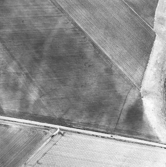 Newbarns, oblique aerial view, taken from the W, centred on the cropmarks of an unenclosed settlement and linear cropmarks.