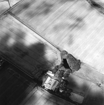 Oblique aerial view centred on the cropmarks of the square barrow, pits and possible souterrain and frost wedges, taken from the S.