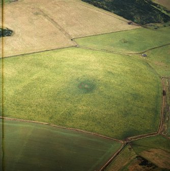 Oblique aerial view centred on the standing stone, taken from the NNE.